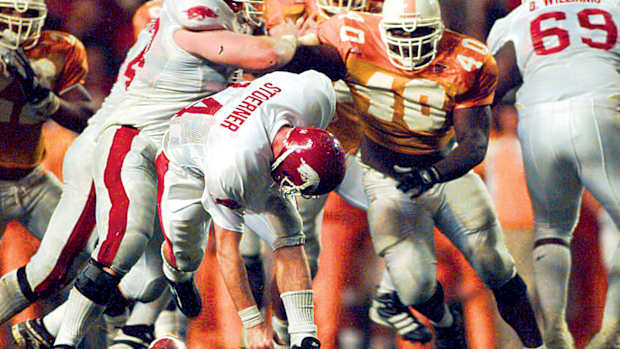 Arkansas' Clint Stoerner fumbles the ball in the closing minutes of play against Tennessee on Nov. 14, 1998, turning the ball over in Knoxville. The Vols' Billy Ratliff (40) recovered and Tennessee won the game 28-24. The play preserved Tennessee's undefeated season and they went on to win the national championship.